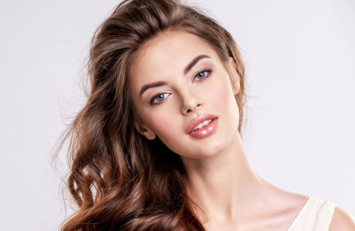 Portrait of a beautiful woman with a long brown hair.