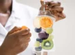 Medical professional holding a vitamin-infused IV bag with fruits inside representing IV Hydration in Kenai, AK