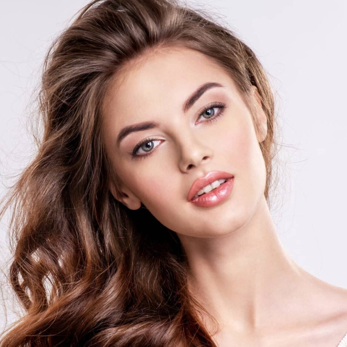 Portrait of a beautiful woman with a long brown hair.